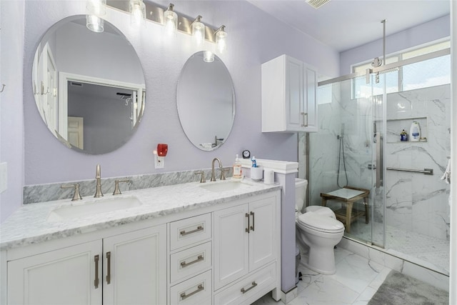 bathroom with toilet, vanity, and walk in shower