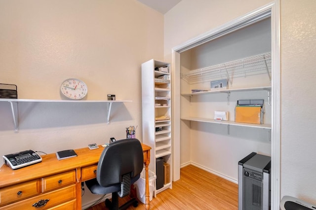 office with light wood-style flooring and baseboards