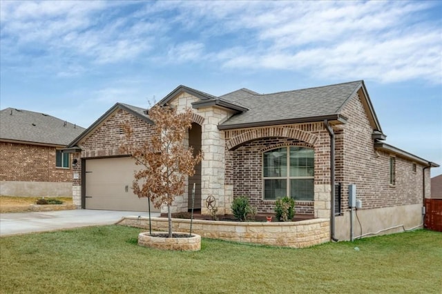 view of front of house with a garage and a front lawn