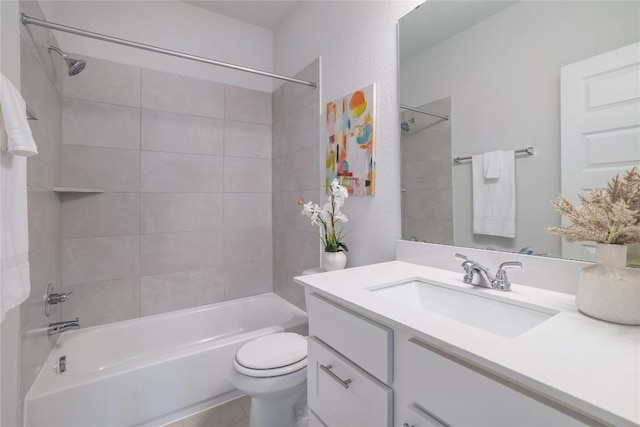 full bathroom with vanity, tiled shower / bath combo, and toilet