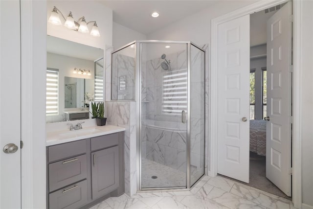 bathroom featuring vanity, a wealth of natural light, and a shower with shower door