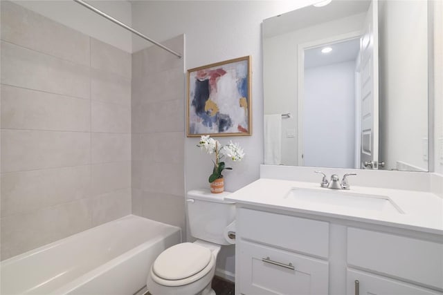 full bathroom with vanity, tiled shower / bath combo, and toilet