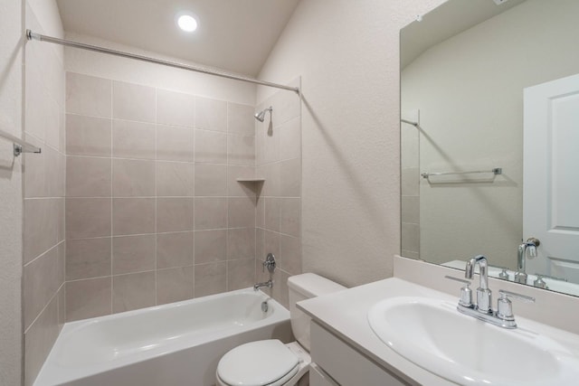 full bathroom with vanity, tiled shower / bath combo, and toilet