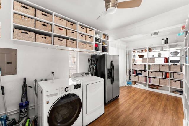 washroom with ceiling fan, hardwood / wood-style floors, electric panel, and washer and clothes dryer