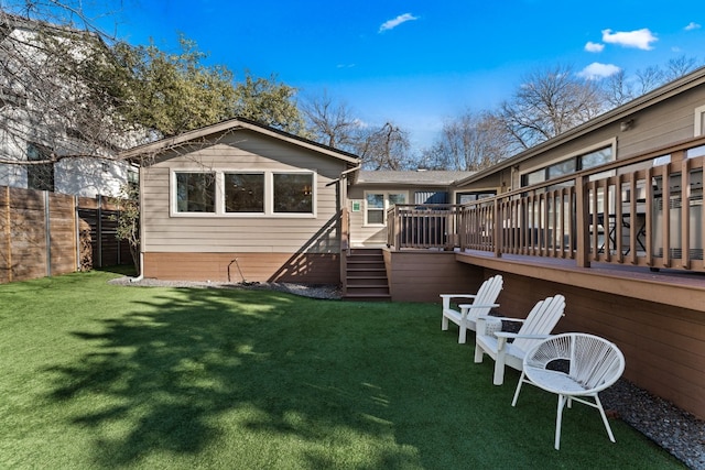 rear view of house with a yard and a deck