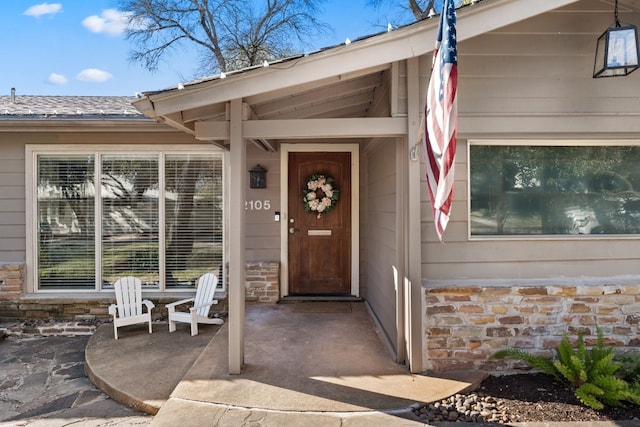 entrance to property featuring a patio area