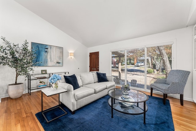 living room featuring hardwood / wood-style flooring and high vaulted ceiling