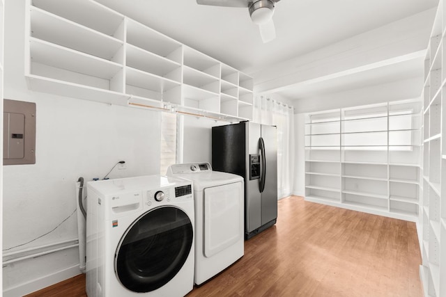 2105 Bowman Ave, Austin, TX 78703 - washroom with washing machine and clothes dryer, electric panel, light wood-type flooring, and a ceiling fan