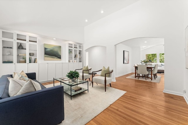 2105 Bowman Ave, Austin, TX 78703 - living area with arched walkways, lofted ceiling, built in features, recessed lighting, and light wood-style floors