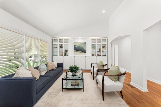 2105 Bowman Ave, Austin, TX 78703 - living area featuring arched walkways, wood finished floors, baseboards, built in features, and recessed lighting
