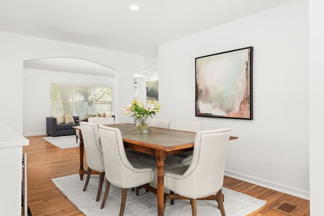2105 Bowman Ave, Austin, TX 78703 - dining area with light wood-style flooring, baseboards, arched walkways, and recessed lighting