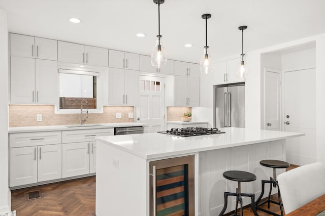 2105 Bowman Ave, Austin, TX 78703 - kitchen with appliances with stainless steel finishes, beverage cooler, a sink, white cabinetry, and recessed lighting