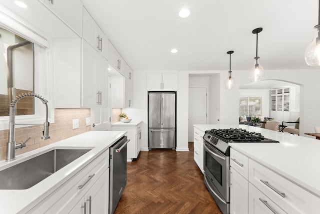 2105 Bowman Ave, Austin, TX 78703 - kitchen with stainless steel appliances, a sink, recessed lighting, white cabinets, and decorative backsplash