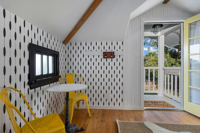 interior space with hardwood / wood-style flooring and lofted ceiling with beams