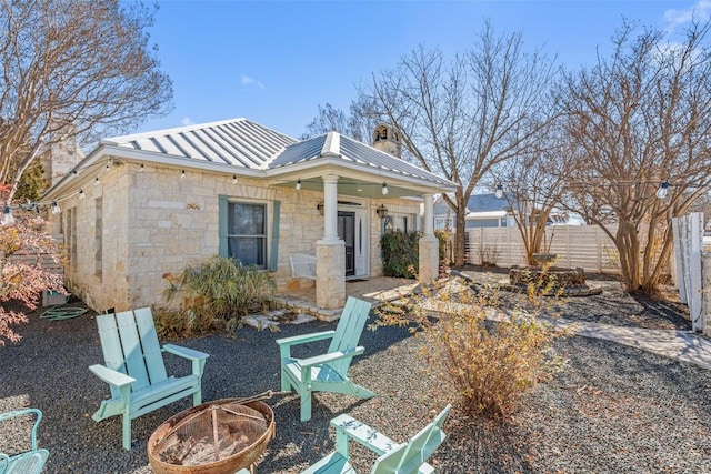 rear view of house featuring an outdoor fire pit