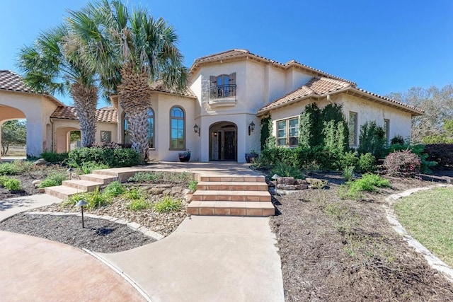 mediterranean / spanish home featuring french doors