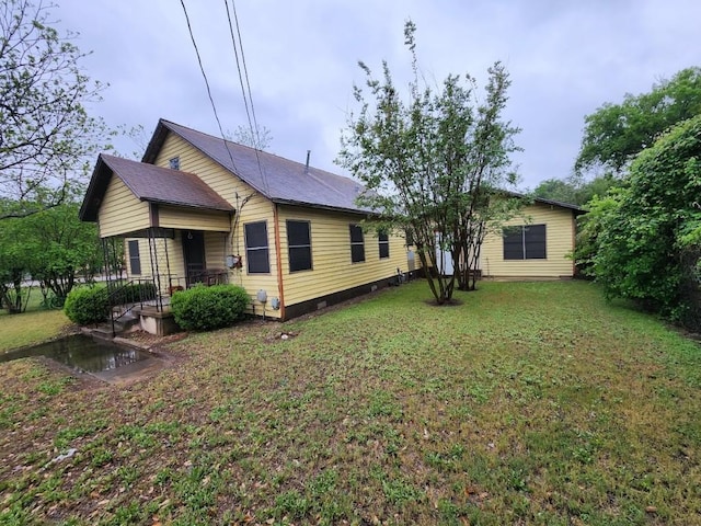 back of house with a yard