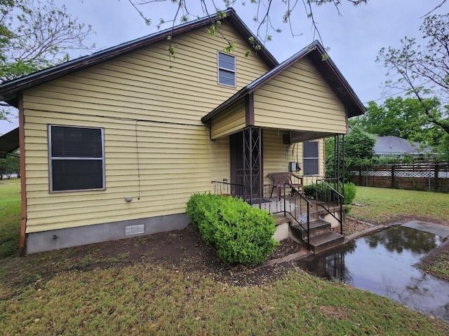 rear view of house with a yard