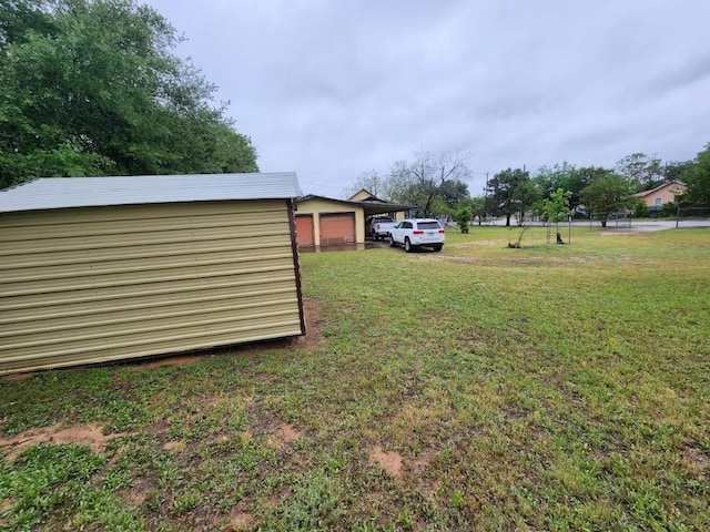 view of yard with a garage and an outdoor structure