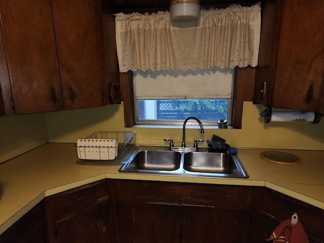 kitchen featuring dark brown cabinets and sink