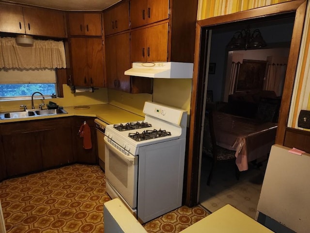 kitchen featuring white gas range and sink