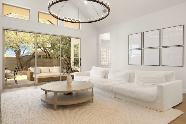 living room featuring a high ceiling and a notable chandelier