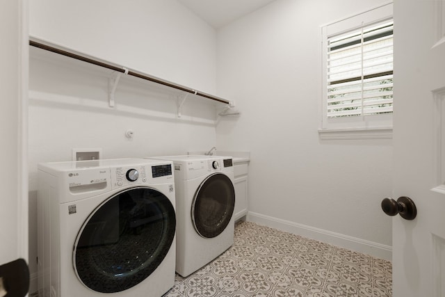 laundry room with cabinets, washer and dryer, and light tile patterned floors