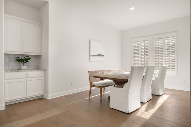 dining space with light hardwood / wood-style floors