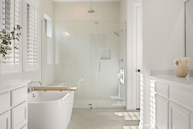 bathroom featuring tile patterned floors, vanity, and plus walk in shower