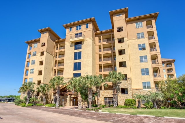 101 W Bank Unit 27, Horseshoe Bay, TX 78657 - view of apartment building / complex with uncovered parking