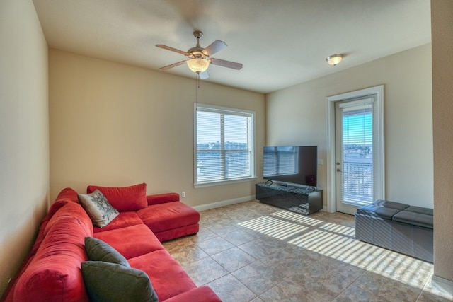 tiled living room featuring ceiling fan