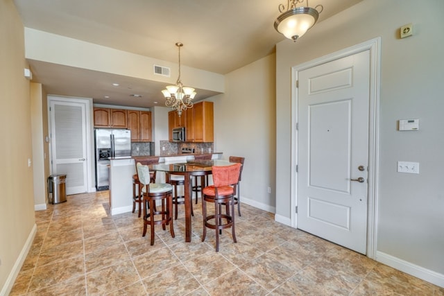 dining area with a notable chandelier