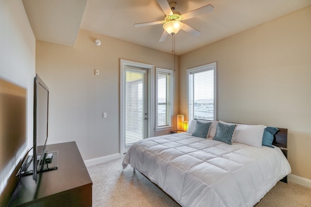 101 W Bank Unit 27, Horseshoe Bay, TX 78657 - bedroom featuring baseboards, light colored carpet, ceiling fan, and access to exterior