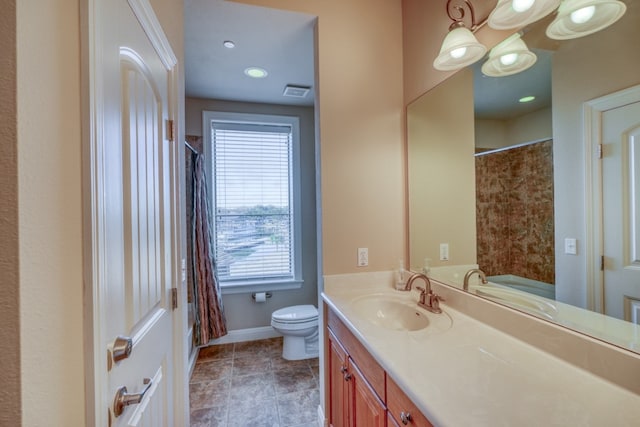 bathroom featuring vanity, walk in shower, and toilet