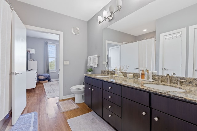 bathroom with vanity, hardwood / wood-style floors, and toilet