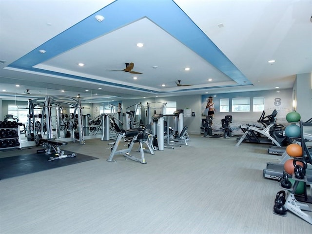 exercise room with carpet and a tray ceiling