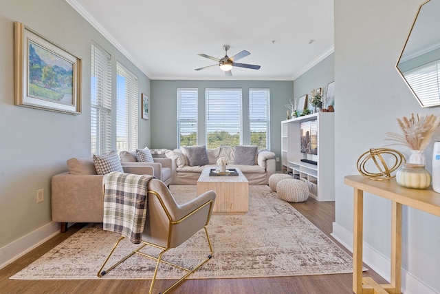 living room with hardwood / wood-style flooring, a wealth of natural light, and ornamental molding