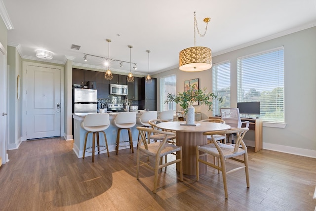 dining room with dark wood-type flooring and ornamental molding