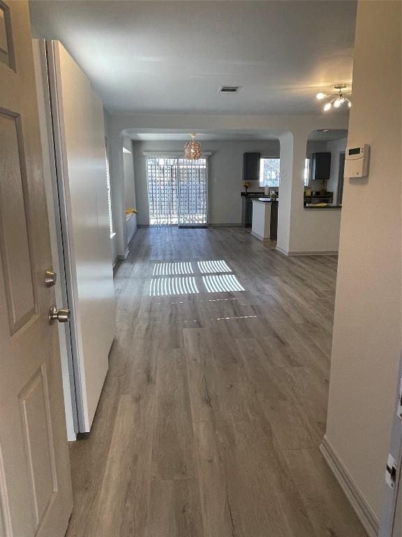 hallway with hardwood / wood-style flooring