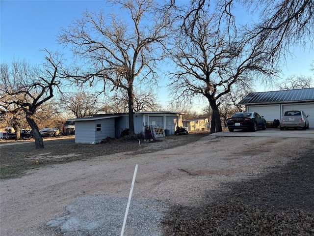 view of property exterior featuring an outbuilding and a garage