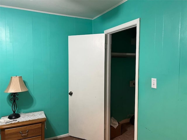 bedroom with crown molding and carpet flooring