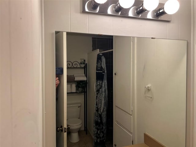 bathroom with tile patterned floors and toilet