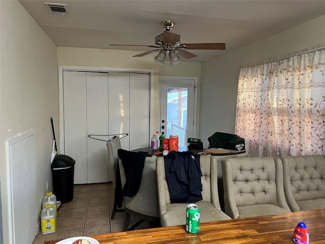 dining area with light tile patterned floors and ceiling fan