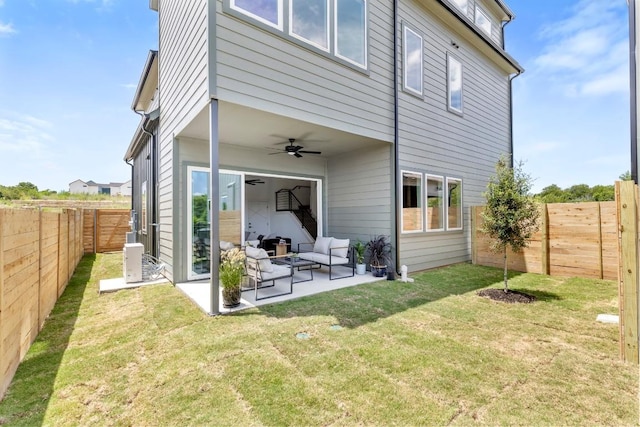 rear view of house with a yard, an outdoor hangout area, a ceiling fan, a patio area, and a fenced backyard