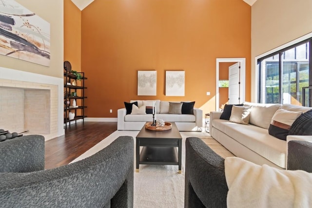 living room featuring hardwood / wood-style floors and a towering ceiling