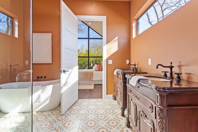 bathroom featuring vanity, tile patterned flooring, and a bathtub