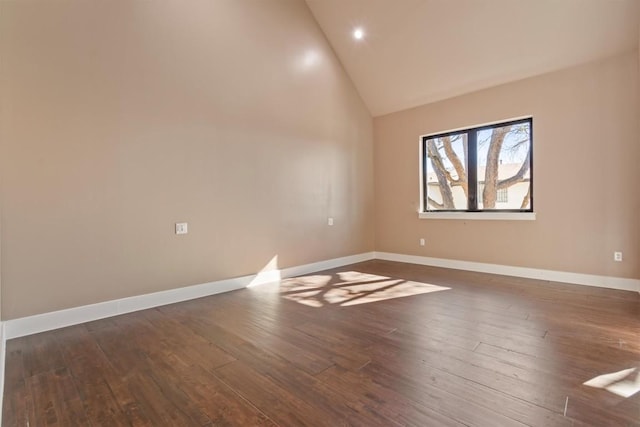 unfurnished room featuring dark wood-type flooring and high vaulted ceiling