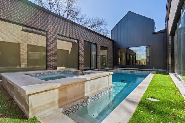 view of swimming pool with an in ground hot tub