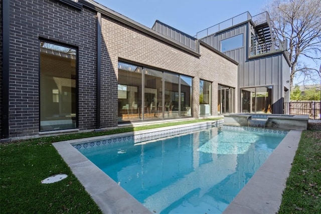 view of pool featuring an in ground hot tub