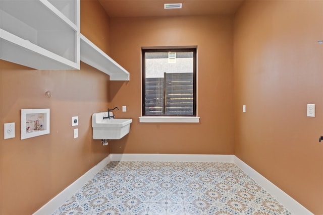 clothes washing area with electric dryer hookup, sink, and hookup for a washing machine